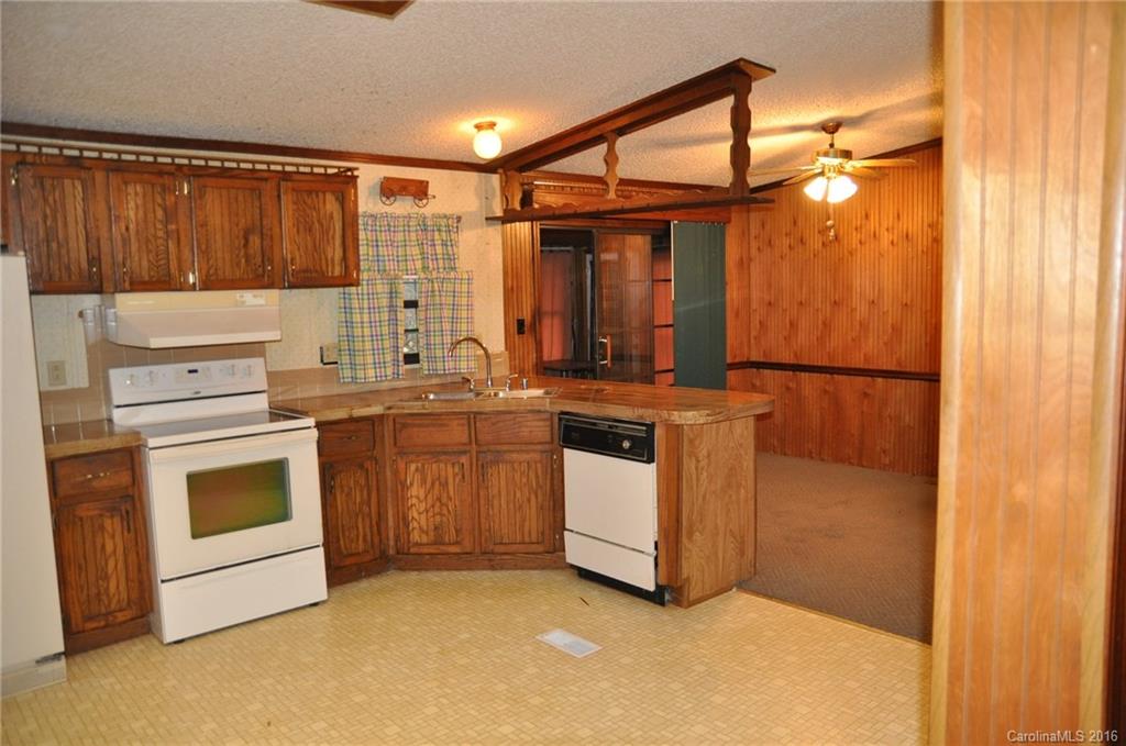 2919 Belk Mill Road Wingate, NC 28174 - Photo 13 of 24 a kitchen with a stove a sink and a refrigerator