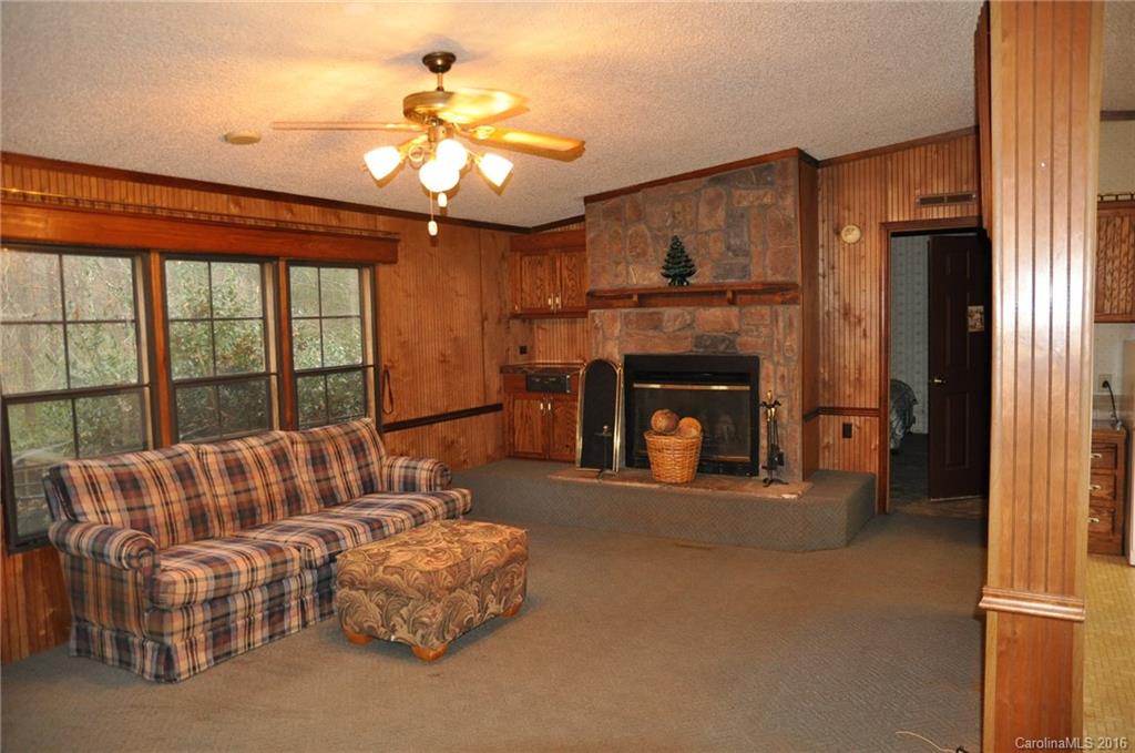 2919 Belk Mill Road Wingate, NC 28174 - Photo 14 of 24 a living room with furniture a fireplace and a chandelier