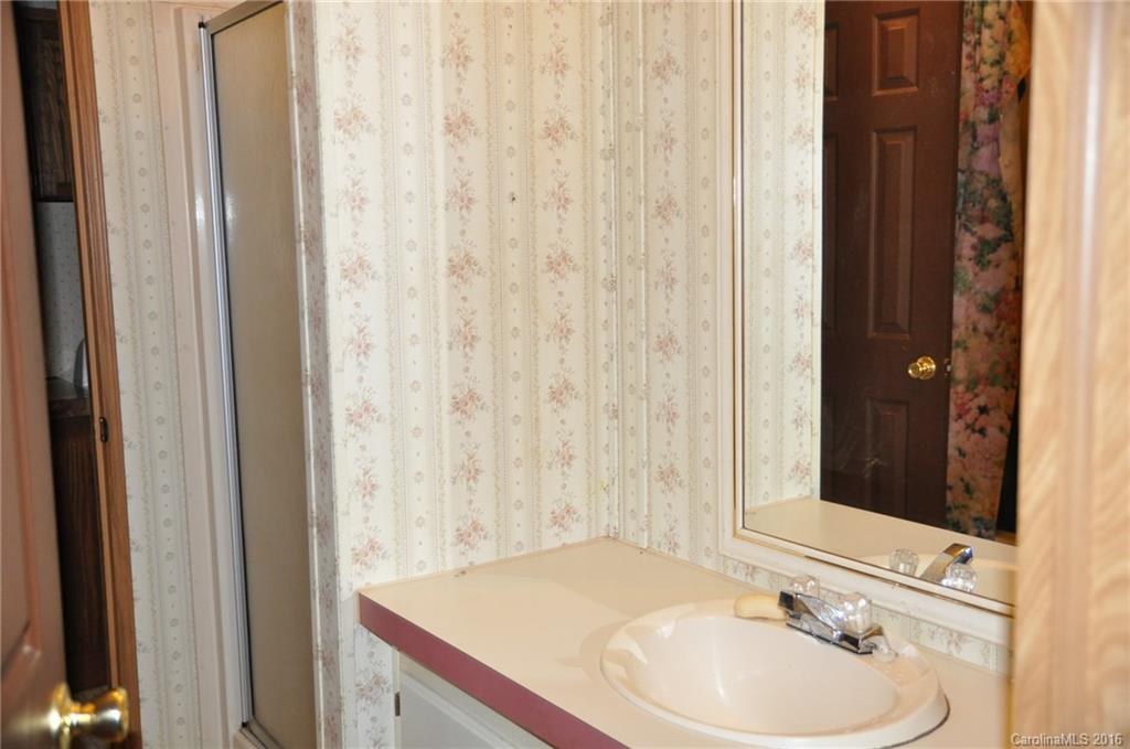 2919 Belk Mill Road Wingate, NC 28174 - Photo 18 of 24 a bathroom with a sink and a mirror