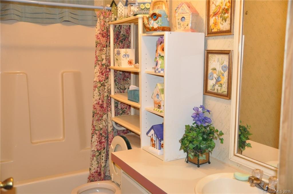 2919 Belk Mill Road Wingate, NC 28174 - Photo 20 of 24 a bath room with a sink and a window