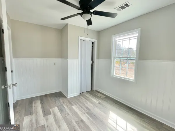 wooden floor in an empty room with a window
