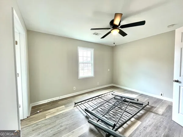 a view of livingroom with hardwood floor and ceiling fan