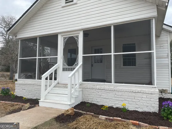 a front view of a house with a garden