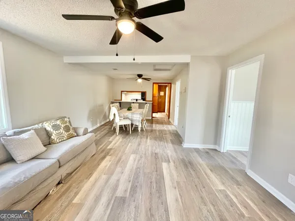 a living room with furniture and a wooden floor