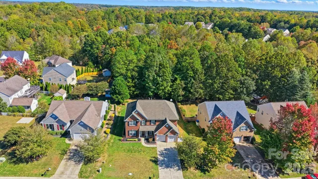 an aerial view of house with yard swimming pool and outdoor seating