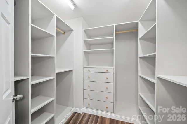 a view of walk in closet with empty racks