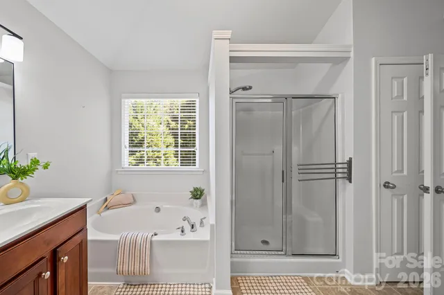 a bathroom with a bathtub and a shower