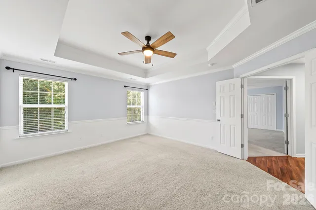 a view of a livingroom with a ceiling fan and window