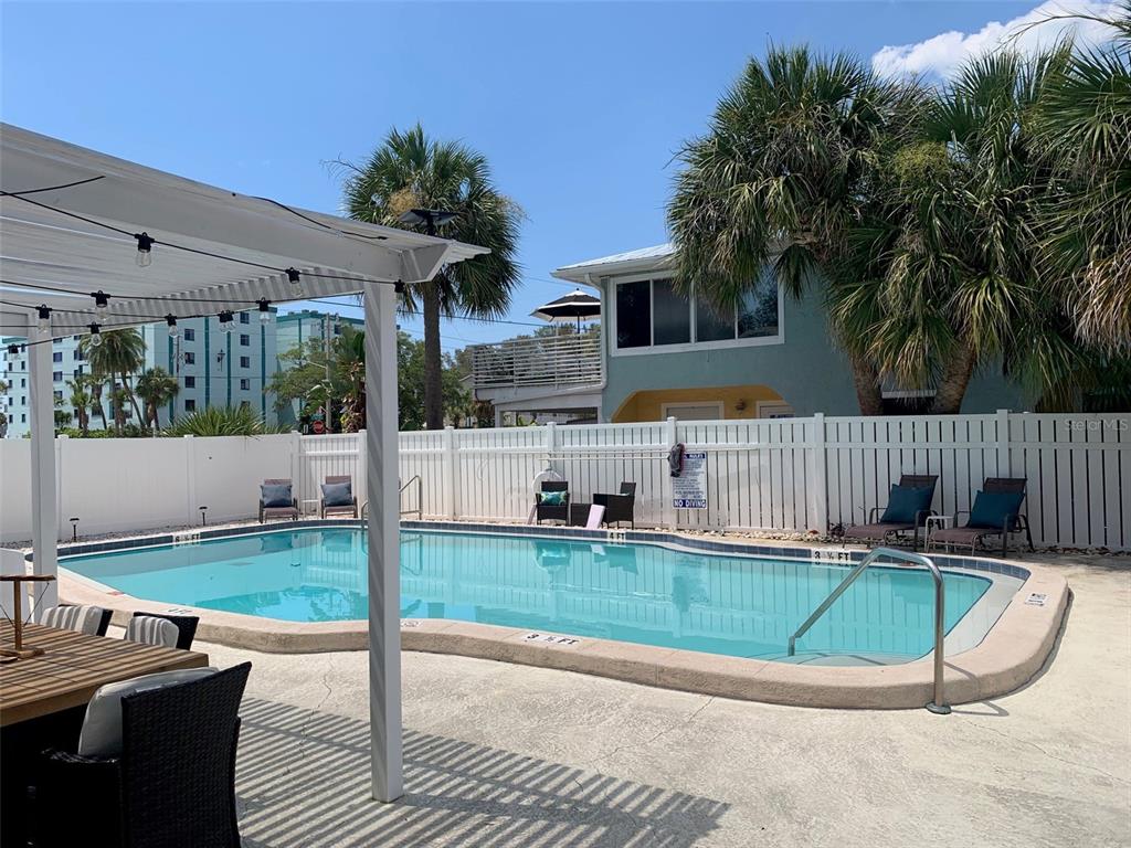 2308 1st Street, Unit 4 Indian Rocks Beach, FL 33785 - Photo 22 of 25 a view of a house with backyard and sitting area