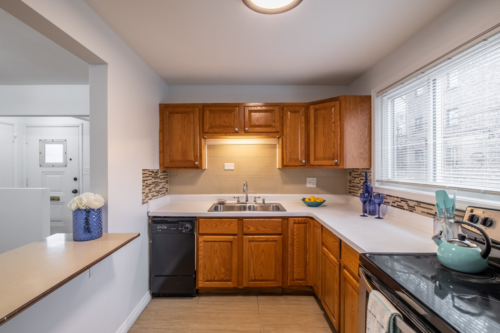 243 Custer Avenue Evanston, IL 60202 - Photo 12 of 31 a kitchen with a sink stove and cabinets