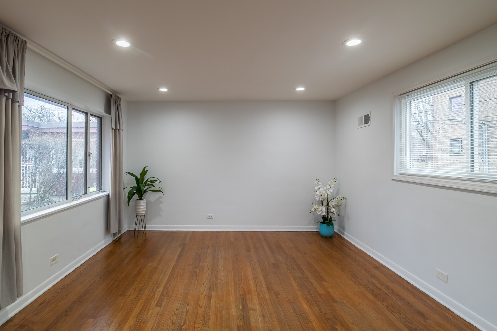 243 Custer Avenue Evanston, IL 60202 - Photo 5 of 31 a view of empty room with wooden floor and windows