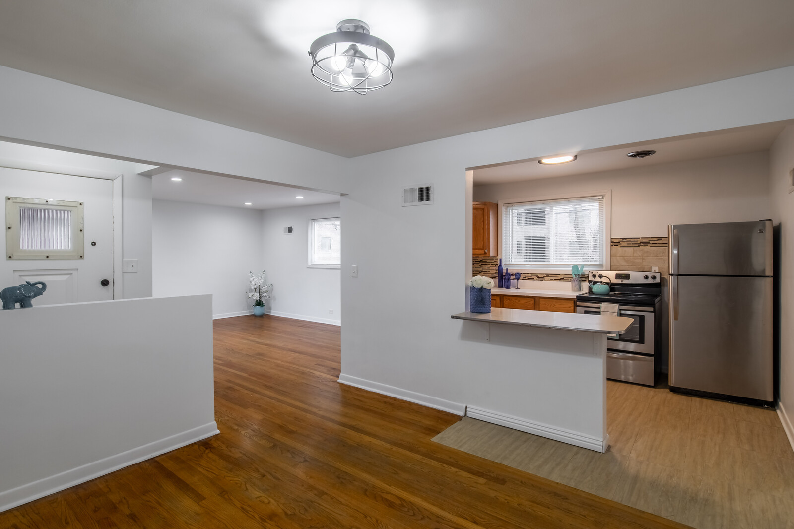 243 Custer Avenue Evanston, IL 60202 - Photo 9 of 31 a kitchen with stainless steel appliances a refrigerator sink and stove