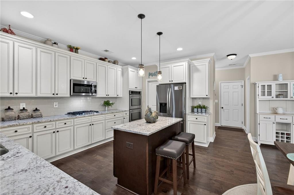 22 Turtle Rock Place Acworth, GA 30101 - Photo 19 of 70 a kitchen with stainless steel appliances kitchen island granite countertop a stove a sink island and a refrigerator