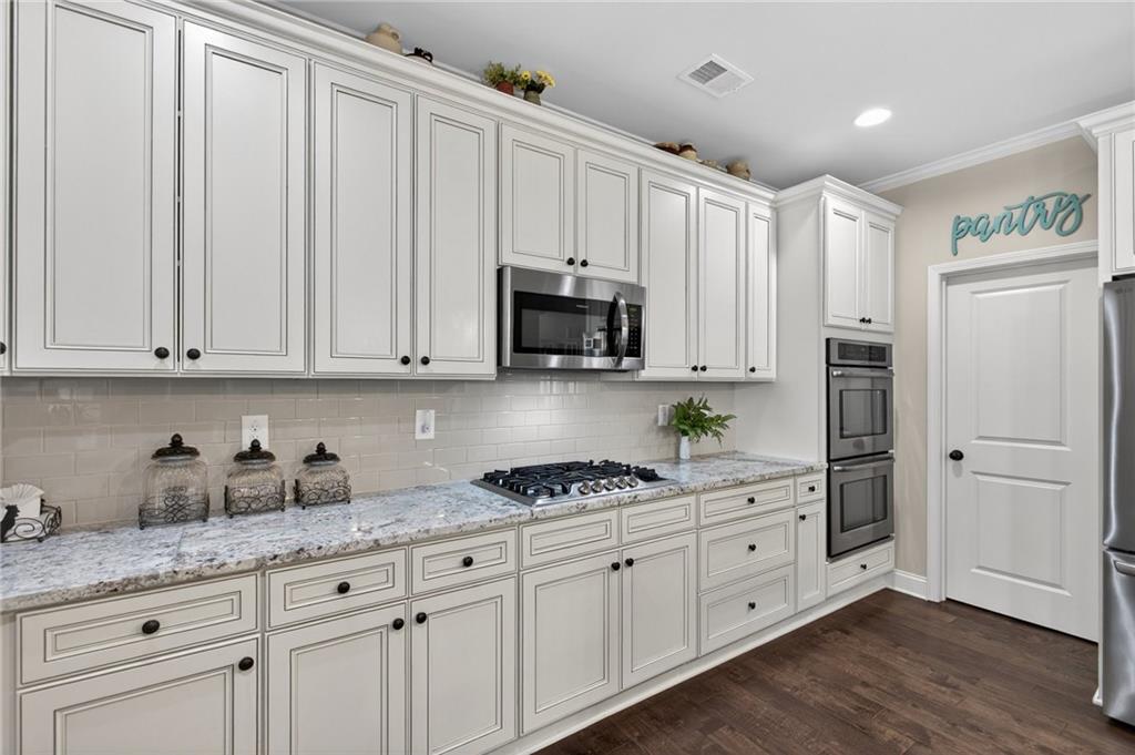 22 Turtle Rock Place Acworth, GA 30101 - Photo 21 of 70 a kitchen with granite countertop white cabinets and stainless steel appliances