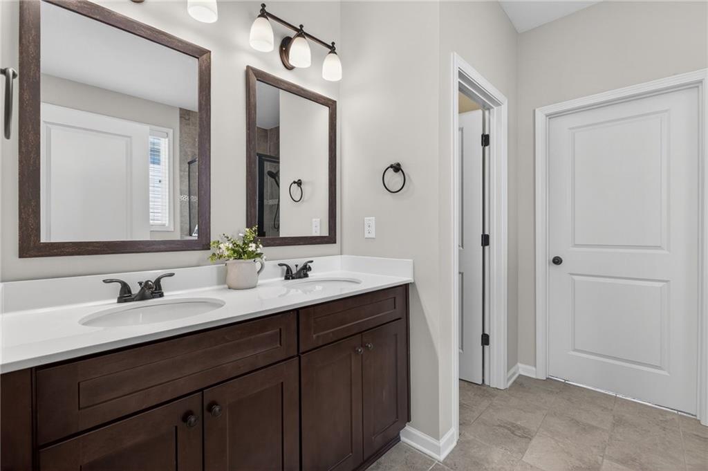 22 Turtle Rock Place Acworth, GA 30101 - Photo 28 of 70 a bathroom with a double vanity sink and mirror