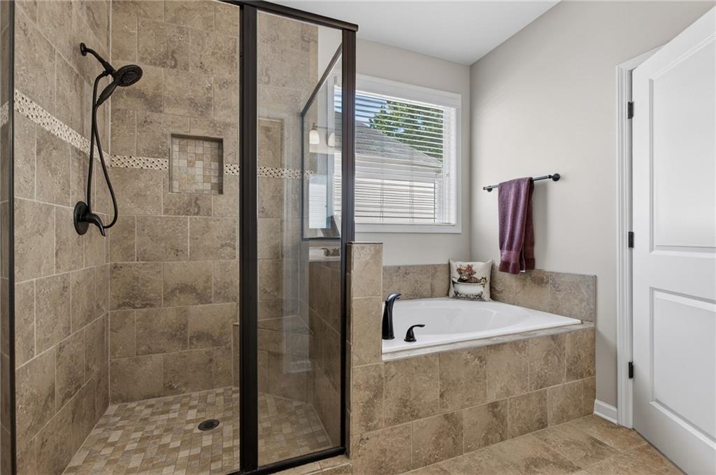 22 Turtle Rock Place Acworth, GA 30101 - Photo 29 of 70 a bathroom with a tub and a shower