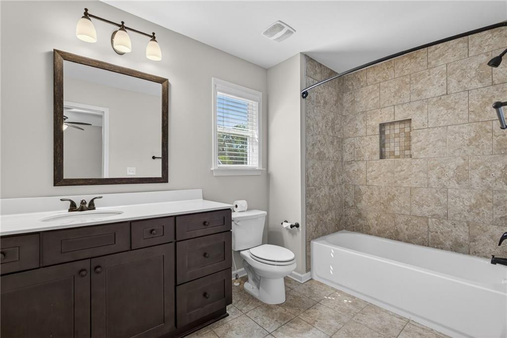22 Turtle Rock Place Acworth, GA 30101 - Photo 38 of 70 a bathroom with a toilet a sink a bathtub and a mirror