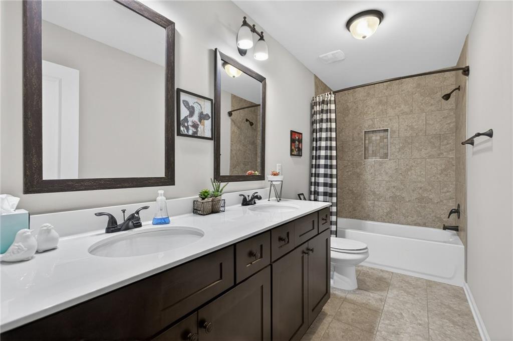 22 Turtle Rock Place Acworth, GA 30101 - Photo 41 of 70 a bathroom with a double vanity sink toilet mirror and bathtub