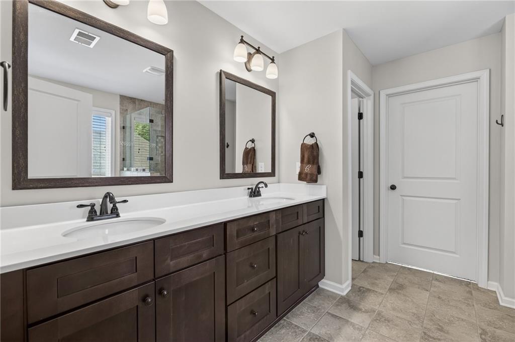 22 Turtle Rock Place Acworth, GA 30101 - Photo 45 of 70 a bathroom with double vanity sinks and a mirror