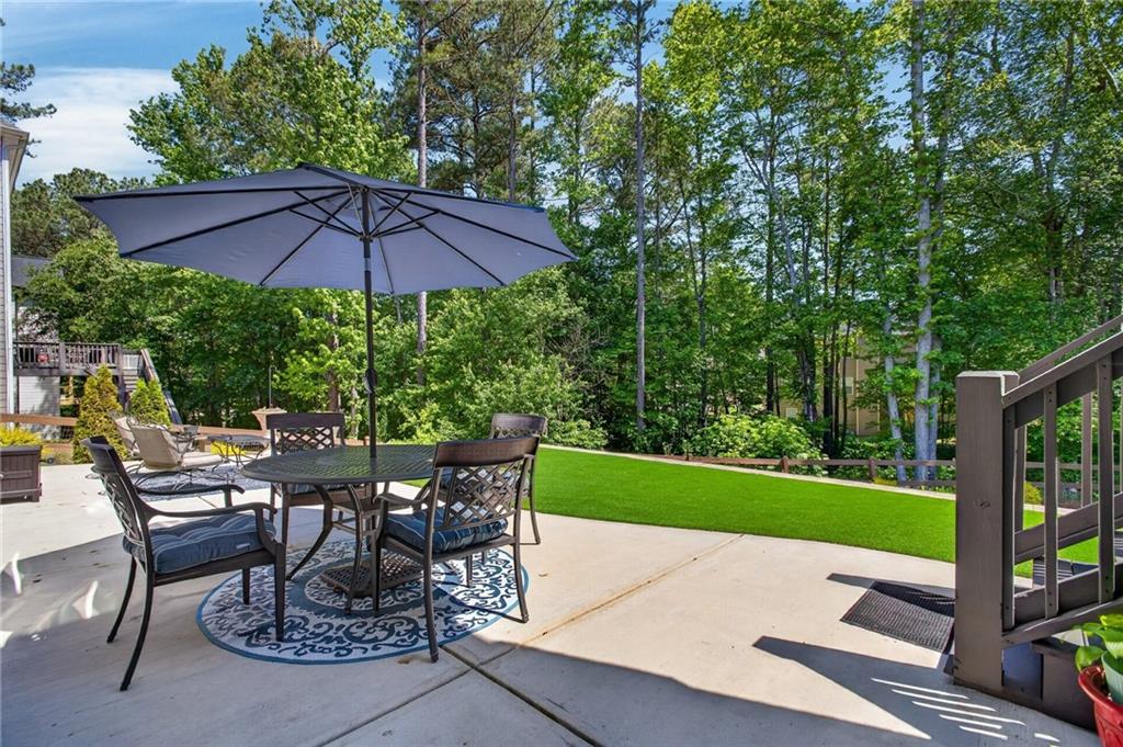 22 Turtle Rock Place Acworth, GA 30101 - Photo 55 of 70 a view of a patio with table and chairs under an umbrella