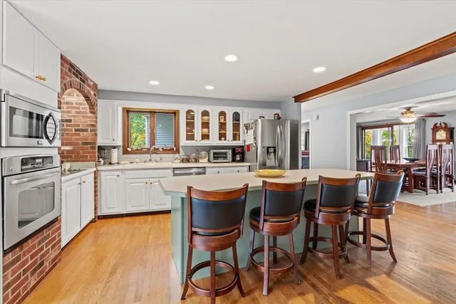 a kitchen with a table chairs sink and cabinets
