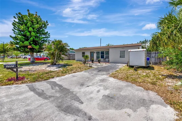 a view of a house with a yard and sitting area
