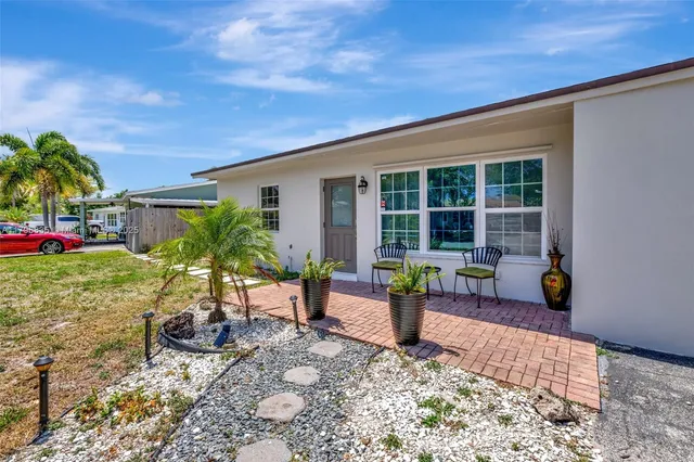 a view of a house with backyard sitting area and porch
