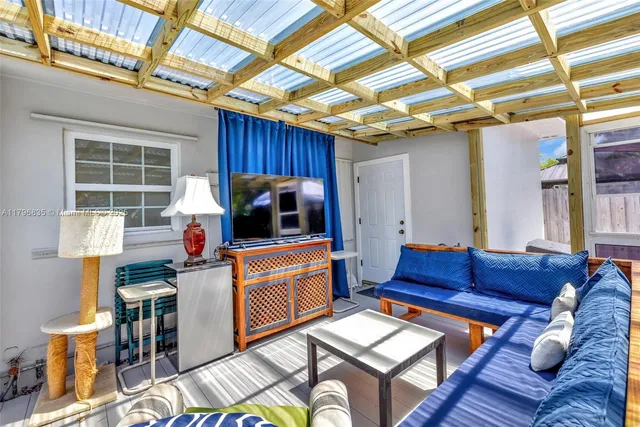 a reading room with furniture and a rug