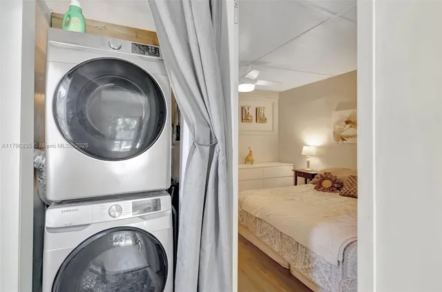 a view of a bedroom with washer and dryer