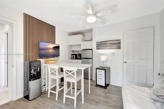 a kitchen with stainless steel appliances a stove a refrigerator and a dining table