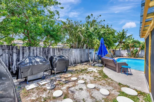 a backyard with wooden fence and trees