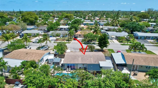 an aerial view of a house with a yard and lake view