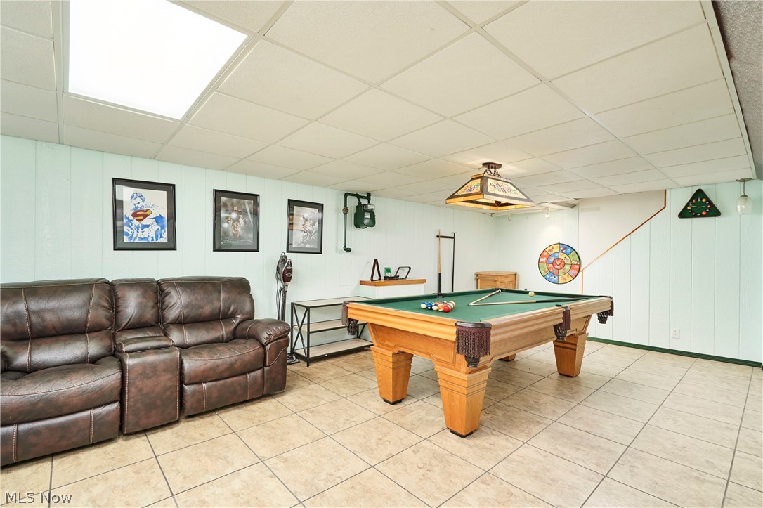 1359 Beaconfield Road Lyndhurst, OH 44124 - Photo 5 of 26 Game room with a drop ceiling, billiards, light tile patterned flooring, and wood walls