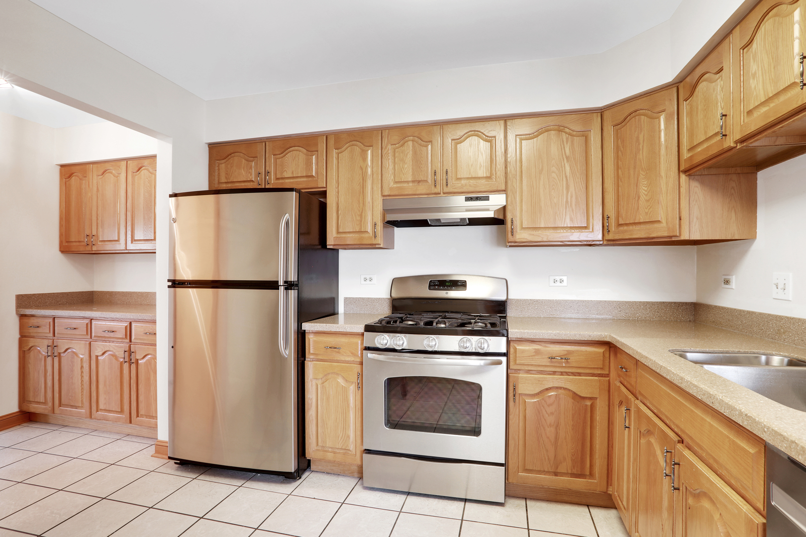 1240 Coldspring Road Elgin, IL 60120 - Photo 2 of 17 a kitchen with a refrigerator sink stove and cabinets
