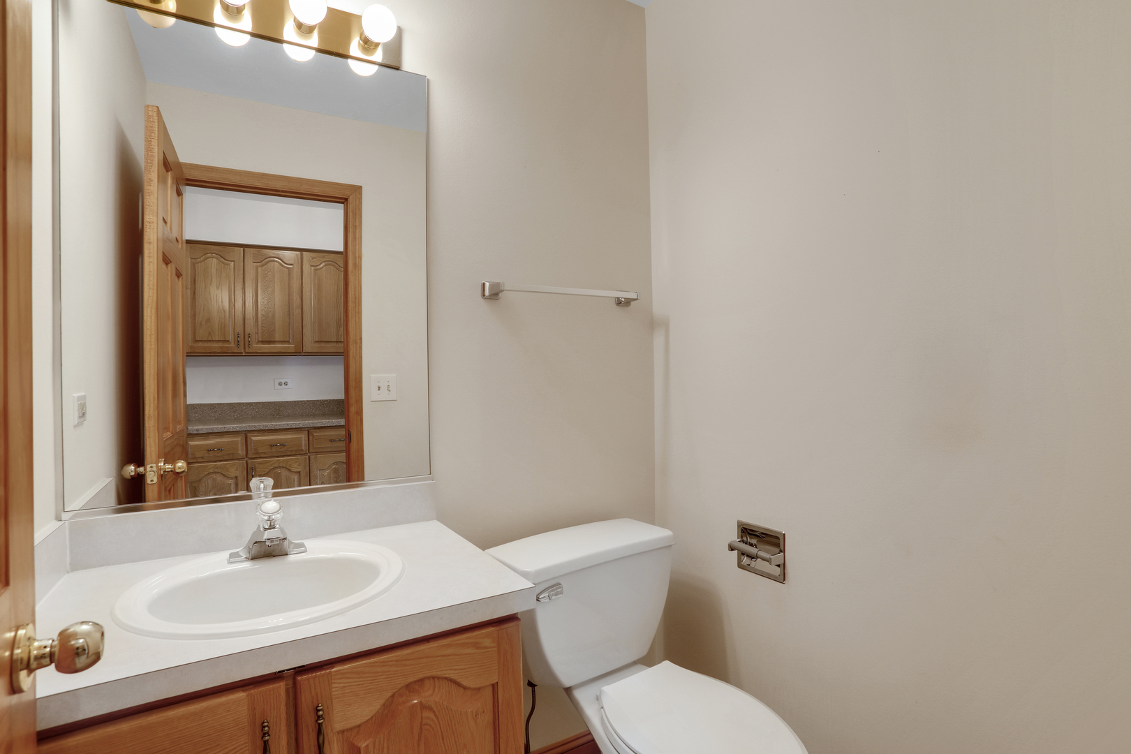 1240 Coldspring Road Elgin, IL 60120 - Photo 11 of 17 a bathroom with a sink a toilet and mirror