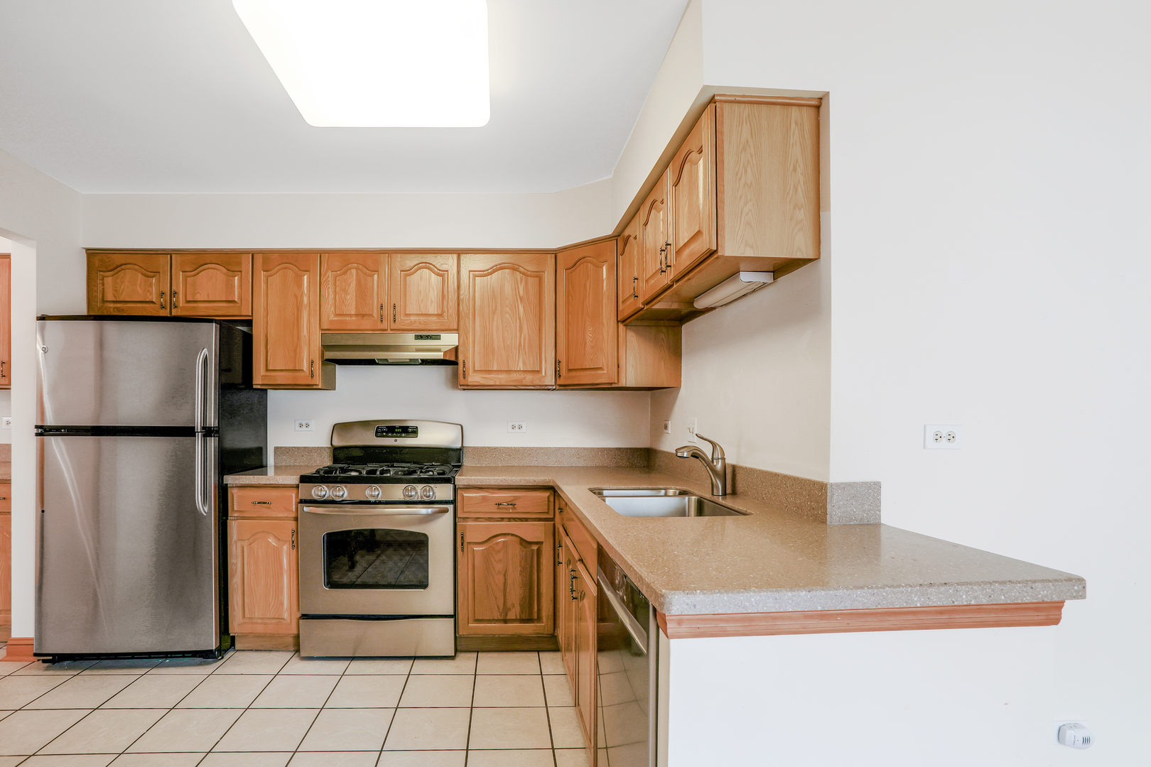 1240 Coldspring Road Elgin, IL 60120 - Photo 3 of 17 a kitchen with a sink a stove a refrigerator a washer and dryer
