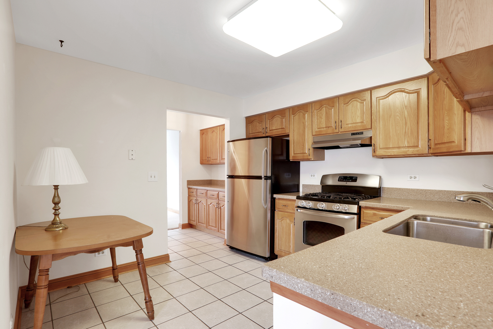 1240 Coldspring Road Elgin, IL 60120 - Photo 4 of 17 a kitchen with stainless steel appliances a stove a sink and a refrigerator