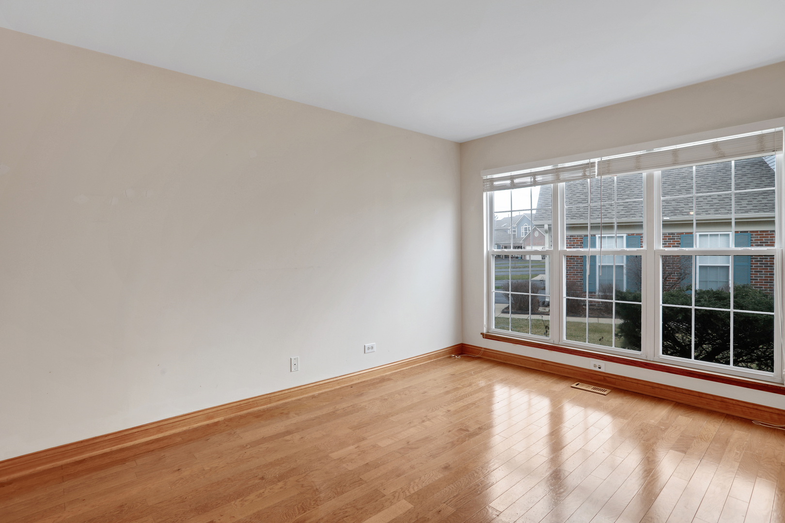 1240 Coldspring Road Elgin, IL 60120 - Photo 5 of 17 an empty room with floor to ceiling window and windows