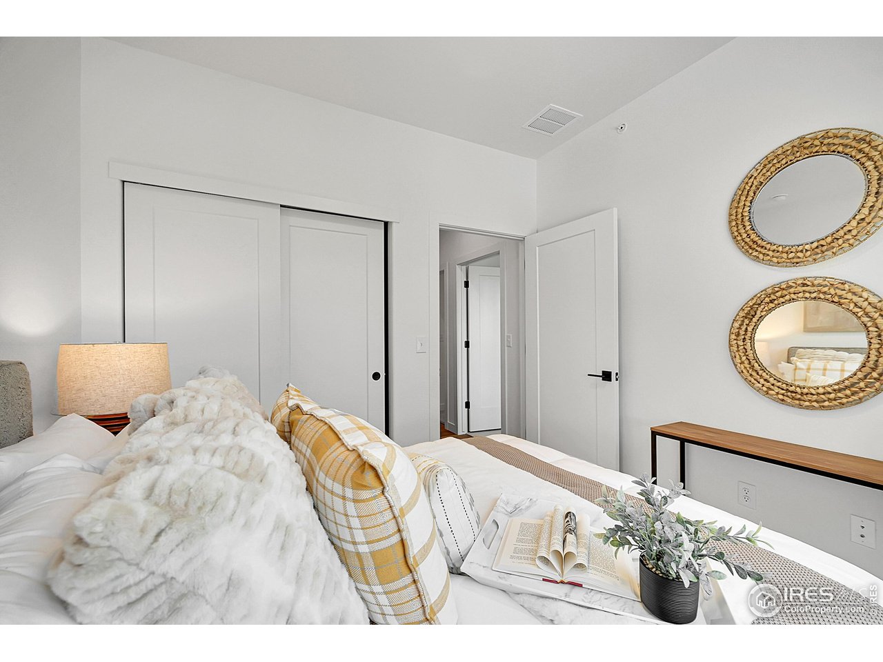 777 East County Line Road Erie, CO 80516 - Photo 11 of 15 a bedroom with a bed and a chandelier