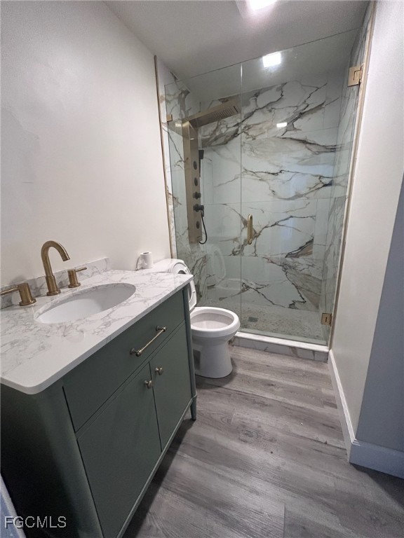 5219 Treetops Drive, Unit I Naples, FL 34113 - Photo 6 of 9 a bathroom with a granite countertop sink toilet a mirror and shower