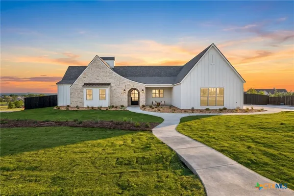 a living room with fireplace furniture and a wooden floor