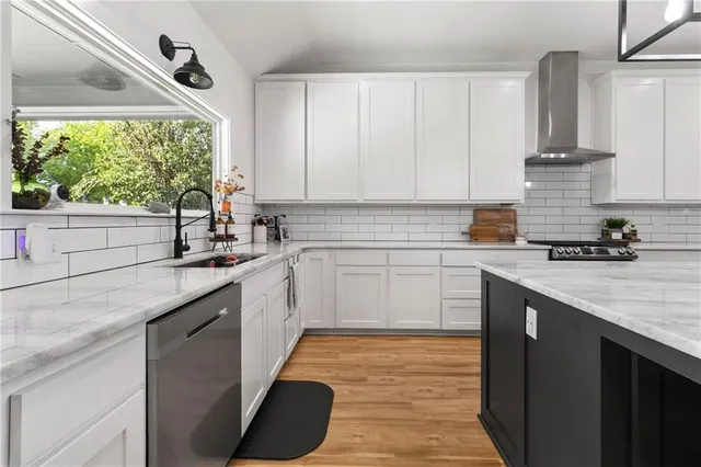 a kitchen with a sink stove and cabinets