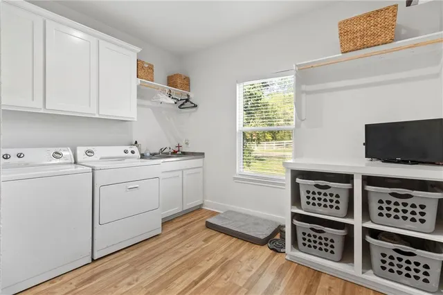a kitchen with stainless steel appliances white cabinets and a window