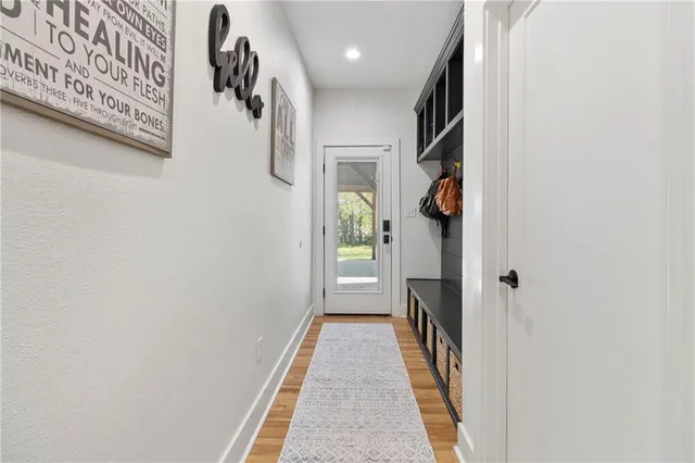 a view of hallway with wooden floor