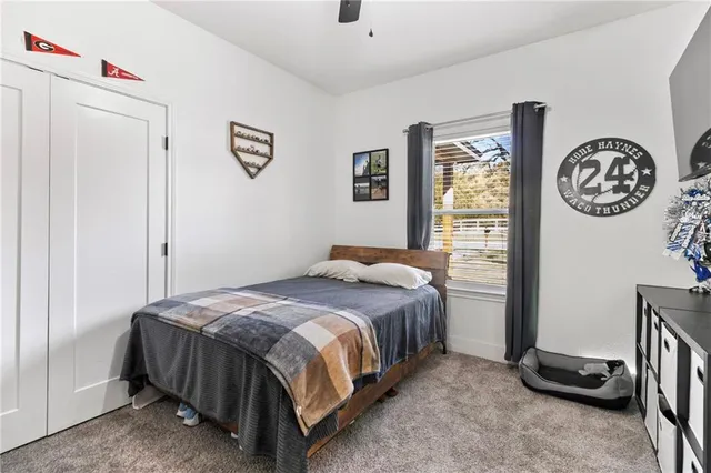 a bedroom with a bed and window