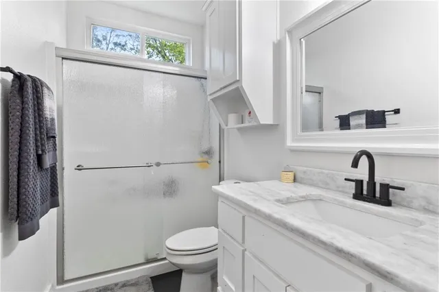 a bed sitting in a bedroom next to a large window