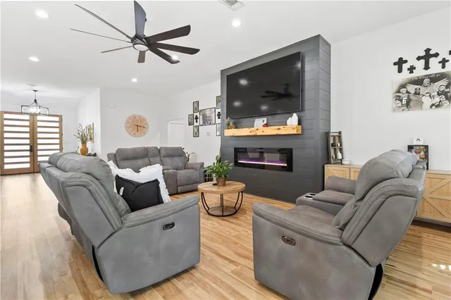 a living room with fireplace furniture and a flat screen tv