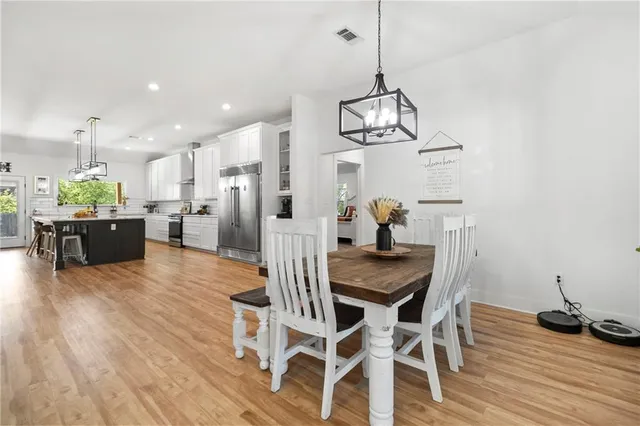 a view of a dining room with furniture wooden floor and chandelier