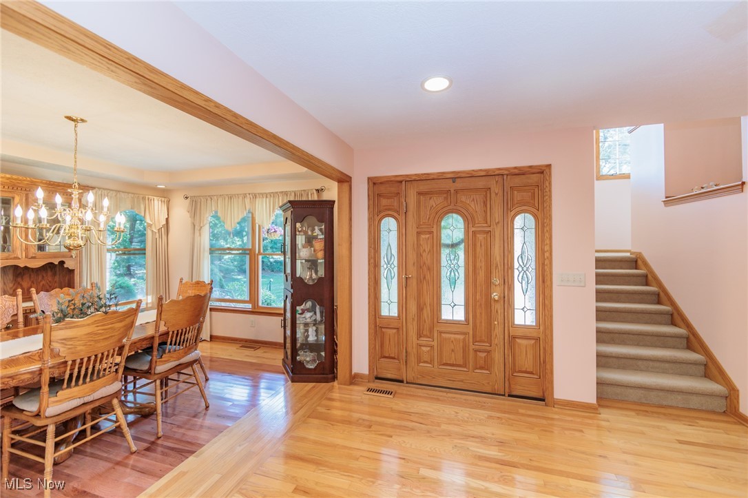 36556 Mills Road Avon, OH 44011 - Photo 13 of 36 Foyer entrance with an inviting chandelier and light hardwood / wood-style flooring