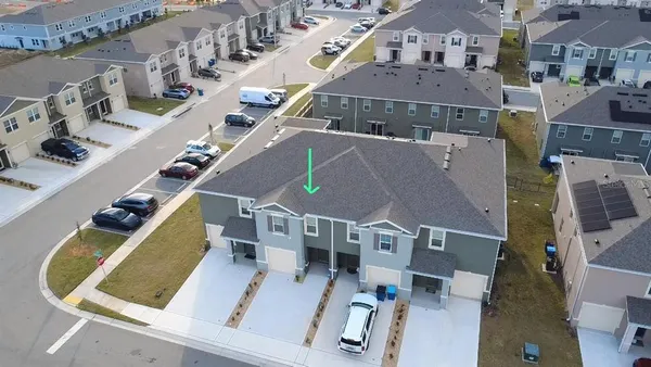 an aerial view of residential houses with outdoor space